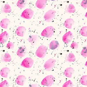 Pink watercolor stains and splatters on cream background