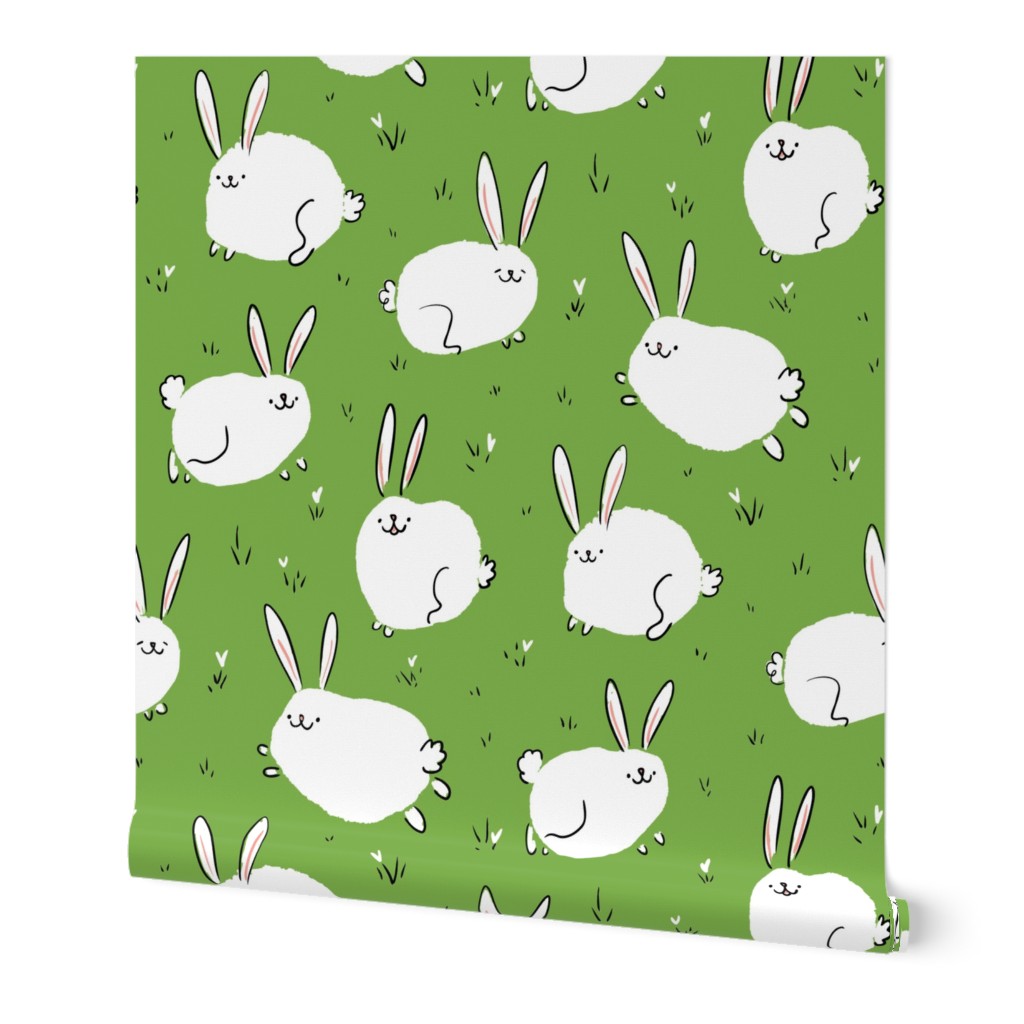 Fluffy cheerful bunnies on a green field Small Scale