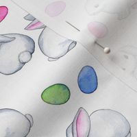 Easter Bunnies with Rainbow Pastel Eggs on white