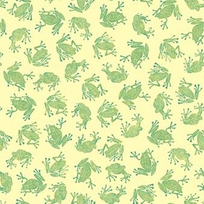 small green frogs on pale yellow 