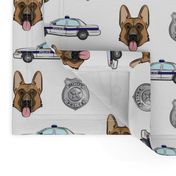 German Shepherd, police badge & car 