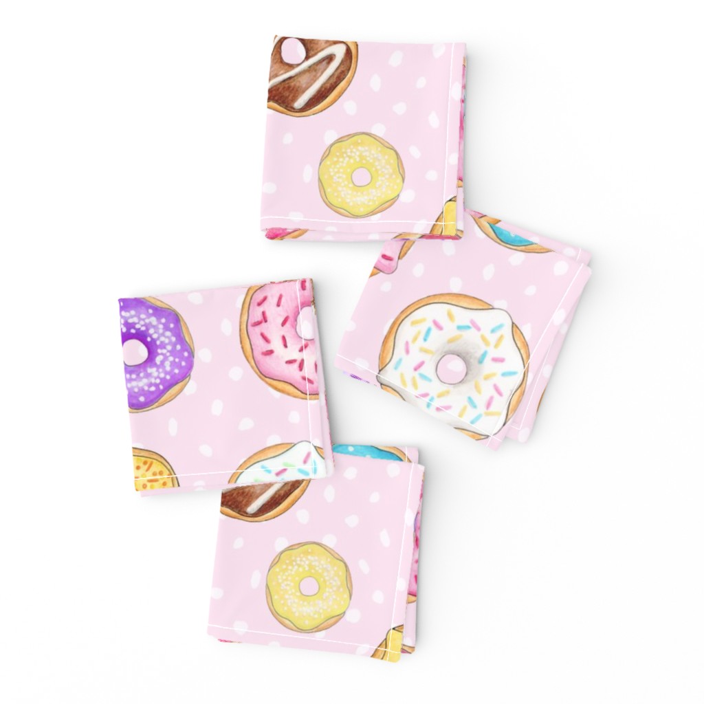 Scattered Rainbow Donuts on pale spotty pink - large scale