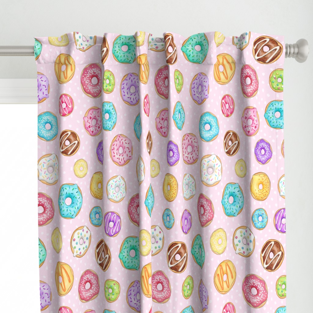 Scattered Rainbow Donuts on pale spotty pink - large scale