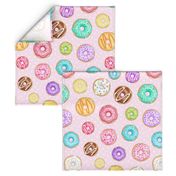 Scattered Rainbow Donuts on pale spotty pink - large scale