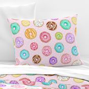 Scattered Rainbow Donuts on pale spotty pink - large scale