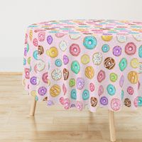 Scattered Rainbow Donuts on pale spotty pink - large scale