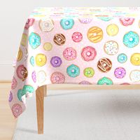 Scattered Rainbow Donuts on pale spotty pink - large scale