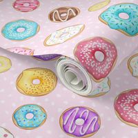 Scattered Rainbow Donuts on pale spotty pink - large scale