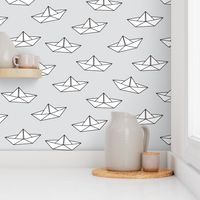 paper boats on grey