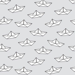 paper boats on grey