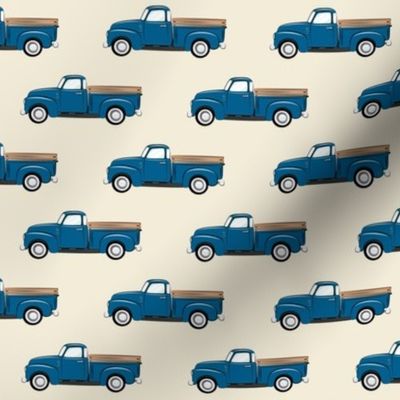 vintage blue truck on dark cream