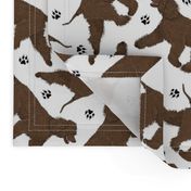 Trotting Irish Water Spaniels and paw prints - white