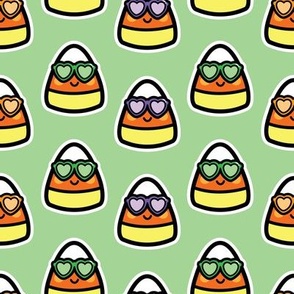 candy corn with sunglasses on green