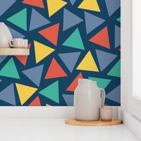 Red yellow blue teal turquoise triangles on a dark blue background. Scattered triangles. Randomly placed triangles. Geometric print. 