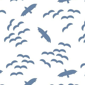 Silhouettes of flying birds. Bird silhouettes blue on a white background. Flock of birds. Swarm of birds. Eagle. Seahawk.