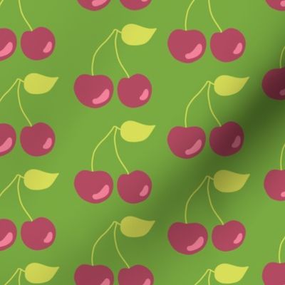 Pairs of cherries on a green background