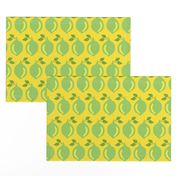 Limes in a row on a yellow background