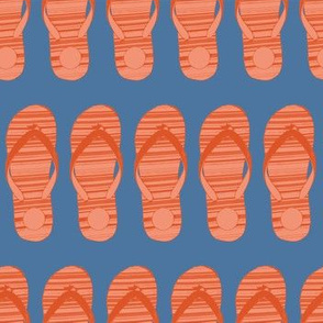 Orange flip flop shoes on a blue background.