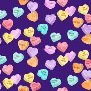 valentines day heart candy - conversation hearts on dark purple