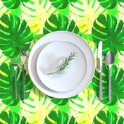 Watercolor green and yellow monstera leaves on light green background