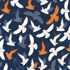 Snowy Owls In flight - white, grey and orange on dark navy