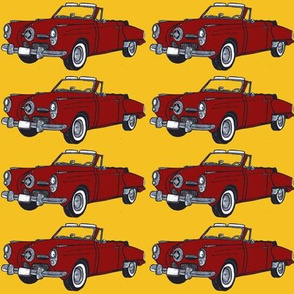 Red 1950 Studebaker convertible on yellow background