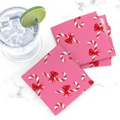 Candy canes with bow on pink