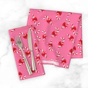 Candy canes with bow on pink