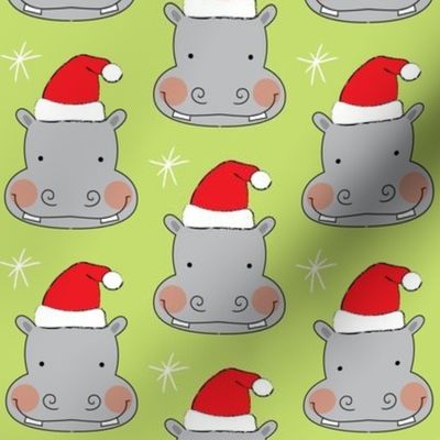 hippo-faces with santa hats on green