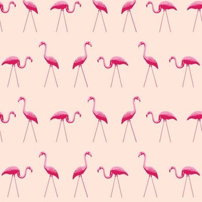 tiny pink plastic flamingos in a row on pink