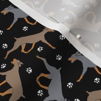 Tiny Trotting uncropped dilute Doberman Pinschers and paw prints - black