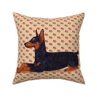 Black and Rust Doberman Lying Down on Pawprints for Pillow