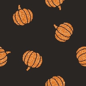 Orange glitter pumpkins on black