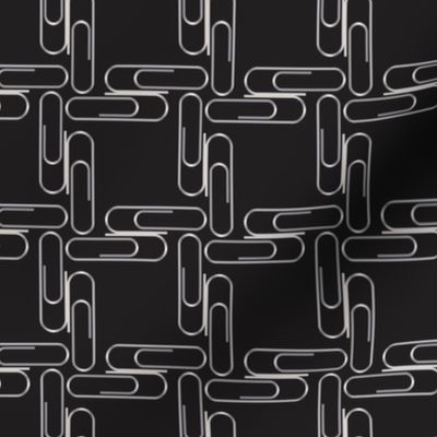 Silver paperclips on black