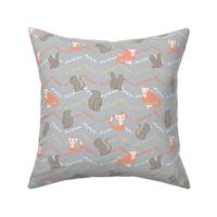 Woodlands creatures orange foxes and grey squirrels on grey chevron background