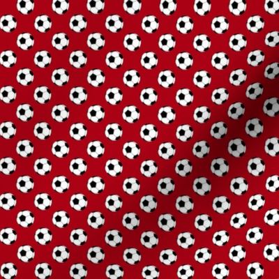 Half Inch Black and White Soccer Balls on Dark Red