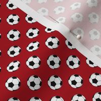 Half Inch Black and White Soccer Balls on Dark Red