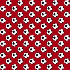 Half Inch Black and White Soccer Balls on Dark Red