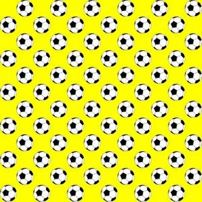 Half Inch Black and White Soccer Balls on Yellow