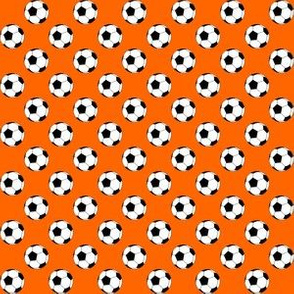 Half Inch Black and White Soccer Balls on Orange