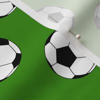 Two Inch Black and White Sports Soccer Balls on Apple Green