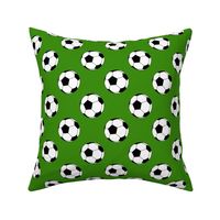 Two Inch Black and White Sports Soccer Balls on Apple Green