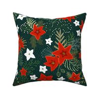 Poinsettia and holly leaves with red berries on dark green