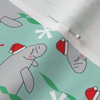 manatees-with-santa-hats-on-teal