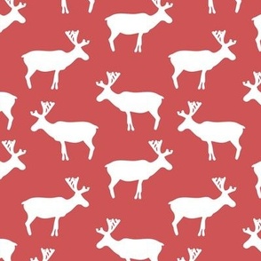  White reindeer pattern on a red background