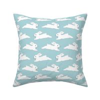 Leaping White Bunnies on Blue