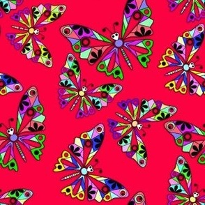 Colorful cut out paper butterflies on a scarlet red background