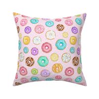 Scattered Rainbow Donuts on pale pink spotty - medium scale