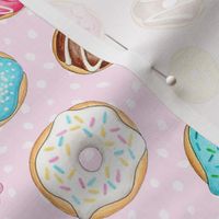 Scattered Rainbow Donuts on pale pink spotty - medium scale