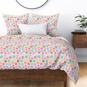 Scattered Rainbow Donuts on pale pink spotty - medium scale